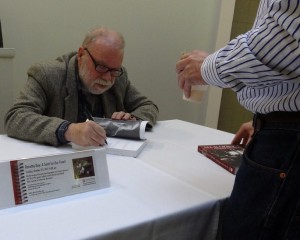 Jim signing books at a talk in Washington DC at Catholic University on Oct. 23, 2011. Photo courtesy of Jim Forest.